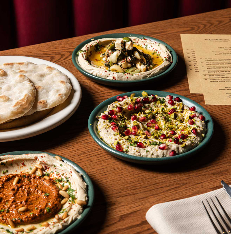 variety of hummuses in the dining room of Pinyon Coastal Mediterranean in Old Town Scottsdale